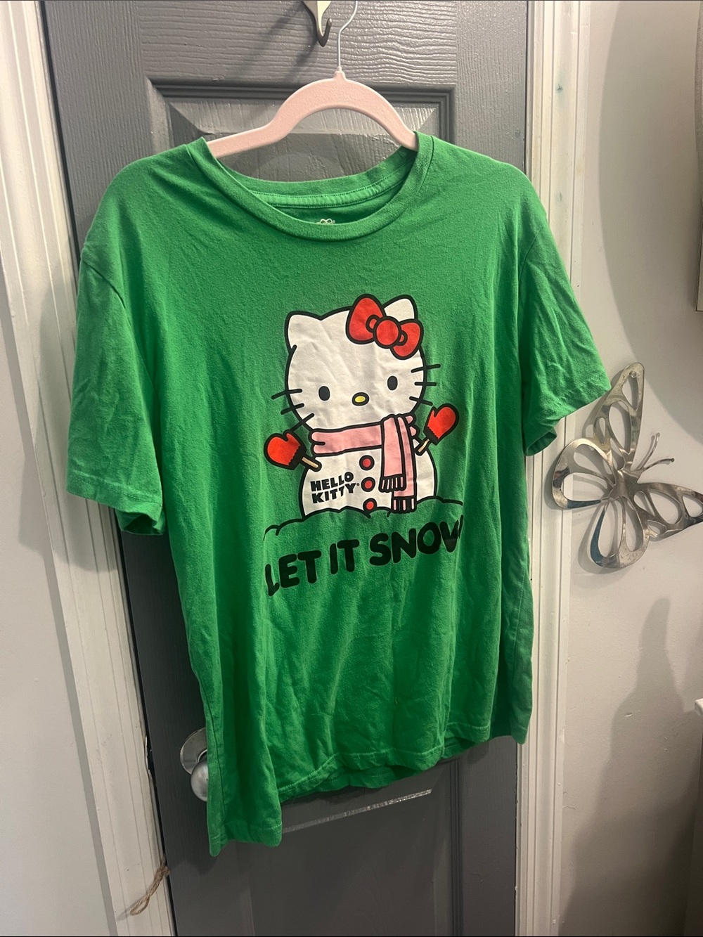 Hello Kitty Green Tee with Festive Graphic and Red Accents